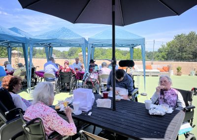 seniors enjoying their meal at rooftop lounge with patio gardens and outdoor seating